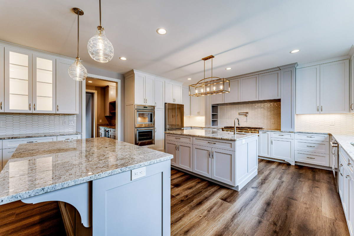 a kitchen with two islands designed by Otero Homes